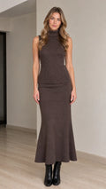 Front full-length view of woman wearing brown sleeveless turtleneck and ribbed maxi skirt set