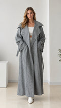 Full front view of women's oversized grey maxi trench coat with tie belt