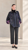 Front view of woman wearing Indigo Blue floral embroidered zip-up jacket with faux leather collar