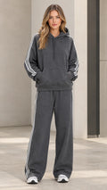 Full front view of model wearing charcoal grey 2-piece hoodie and wide-leg sweatpants set with side stripes