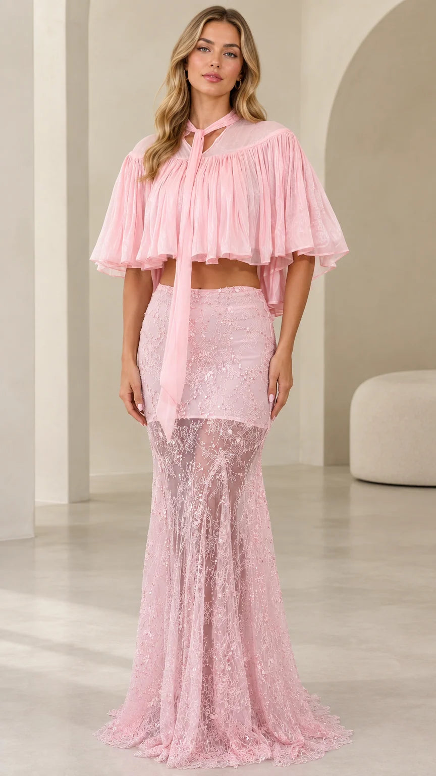 Front view of model wearing pink two-piece sequin lace maxi dress with pleated capelet