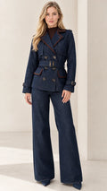 Front full-length view of woman wearing navy blue double-breasted belted blazer and matching wide-leg pants set