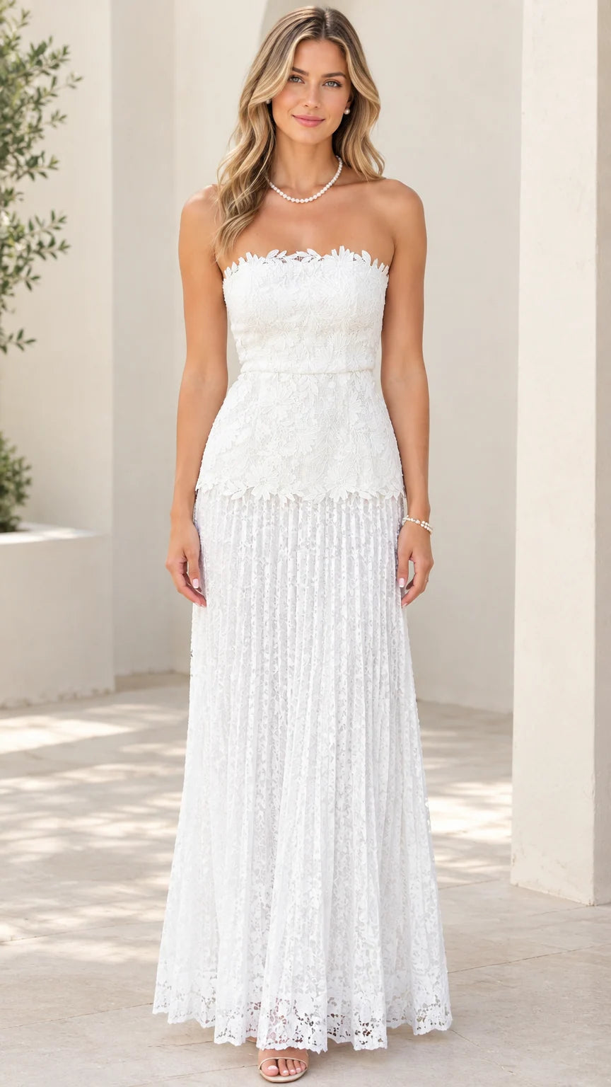 Front view of woman wearing white strapless floral lace maxi dress with scalloped neckline