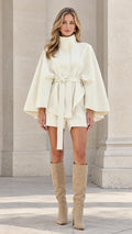 Front view of cream high-neck belted cape coat and shorts set