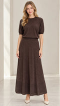 Front full-length view of model wearing coffee brown shimmer knit top and matching maxi skirt set