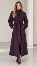 Front view of woman wearing deep plum herringbone maxi wrap coat with belt