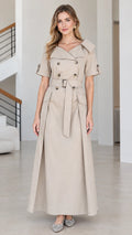 Front view of woman wearing beige double-breasted short-sleeve trench maxi dress with belt