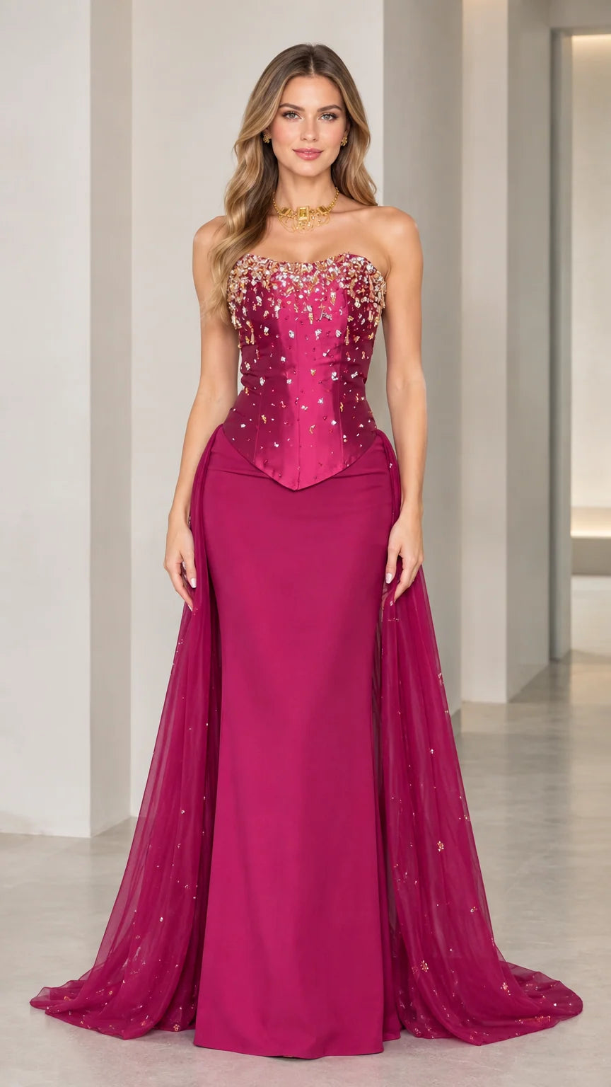 Front view of model wearing magenta strapless beaded corset evening gown with tulle overskirt train