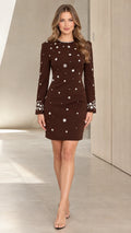 Front full-length view of woman wearing chocolate brown rhinestone floral embellished long sleeve mini dress