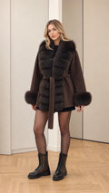 Front view of women's hooded faux fur trim wrap coat in chocolate brown with tie belt