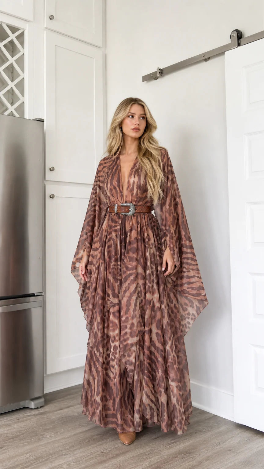 Front full-length view of woman wearing brown abstract animal print kimono maxi dress with western belt