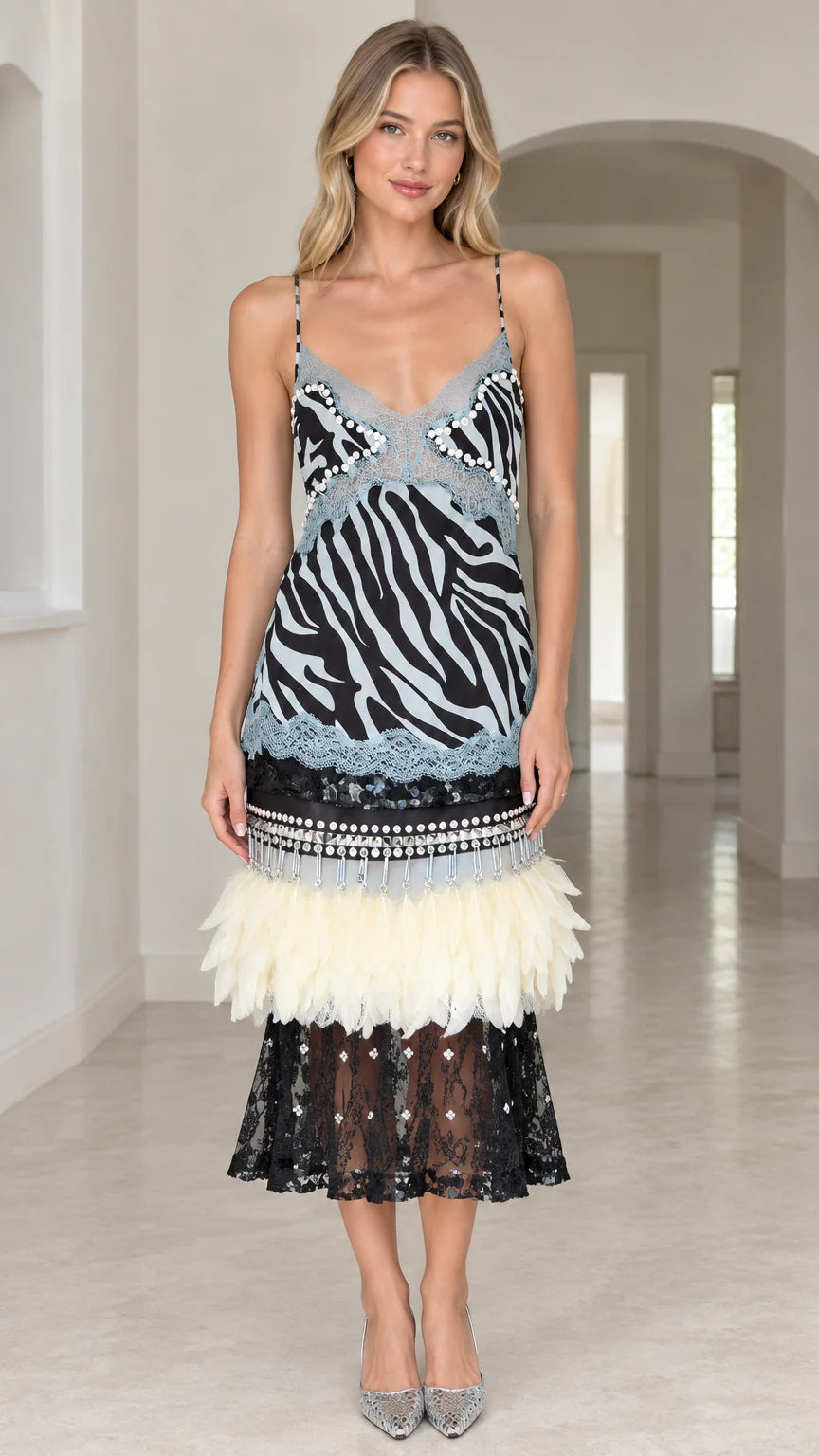 Front view of model wearing Sky Blue zebra print midi dress with feather hem