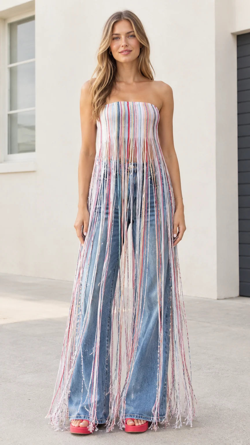 Model wearing multi-color blue strapless striped maxi fringe tube top with wide-leg jeans front view