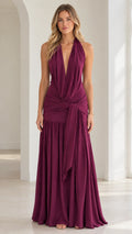 Burgundy plunging halter neck maxi dress with ruched waist and side drape front view