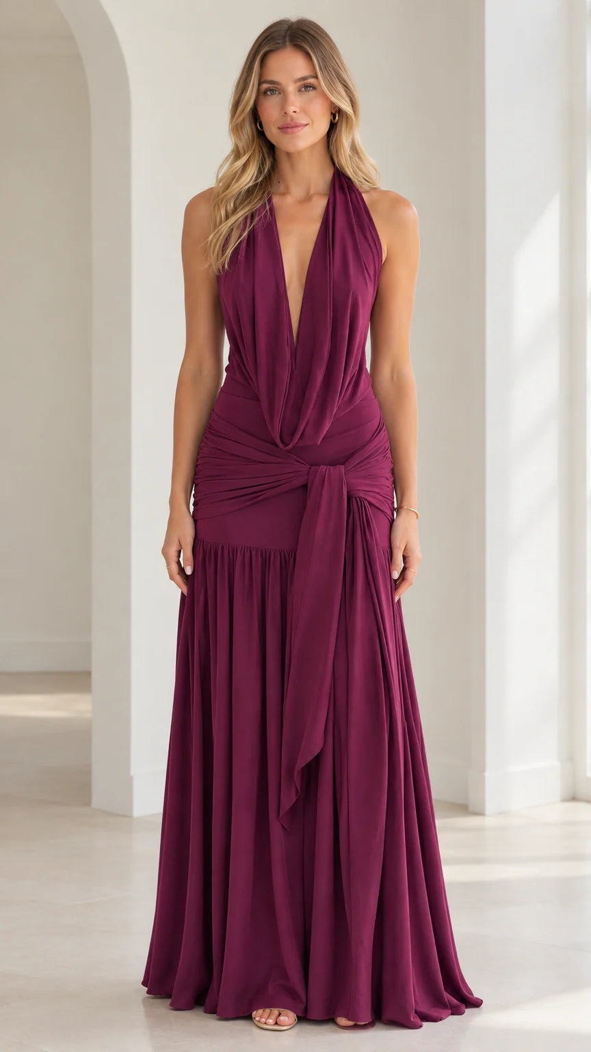Burgundy plunging halter neck maxi dress with ruched waist and side drape front view