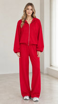 Front view of woman wearing red 2-piece zip-up hoodie and wide-leg pants tracksuit set