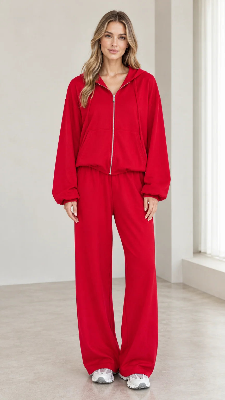 Front view of woman wearing red 2-piece zip-up hoodie and wide-leg pants tracksuit set