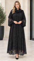 Front full-length view of woman wearing black floral lace maxi abaya with ruffle sleeves