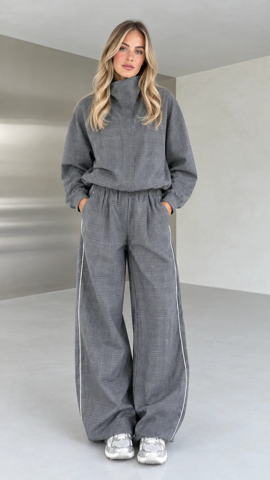 Full front view of model wearing grey plaid high-neck top and wide-leg pants set