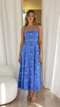 Front view of woman wearing blue floral embroidered midi dress