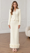 Front full-length view of woman wearing cream tweed two-piece blazer and ruffle hem maxi skirt set