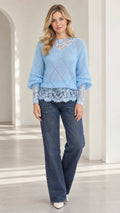 Light blue women's diamond knit sweater with floral lace trim paired with wide-leg jeans