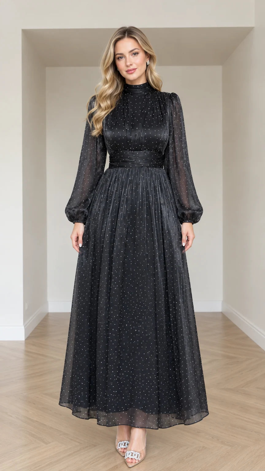 Front full-length view of woman wearing Black sparkle dot mock neck long sleeve maxi dress