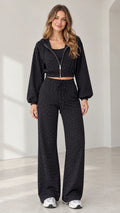 Full front view of model wearing black rhinestone cropped zip hoodie and wide-leg pants set