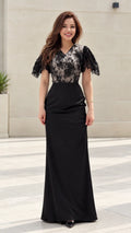 Front view of model wearing black floral lace flutter sleeve maxi evening gown