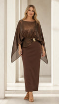 Front view of woman wearing metallic brown shimmer capelet maxi dress with gold waist brooch