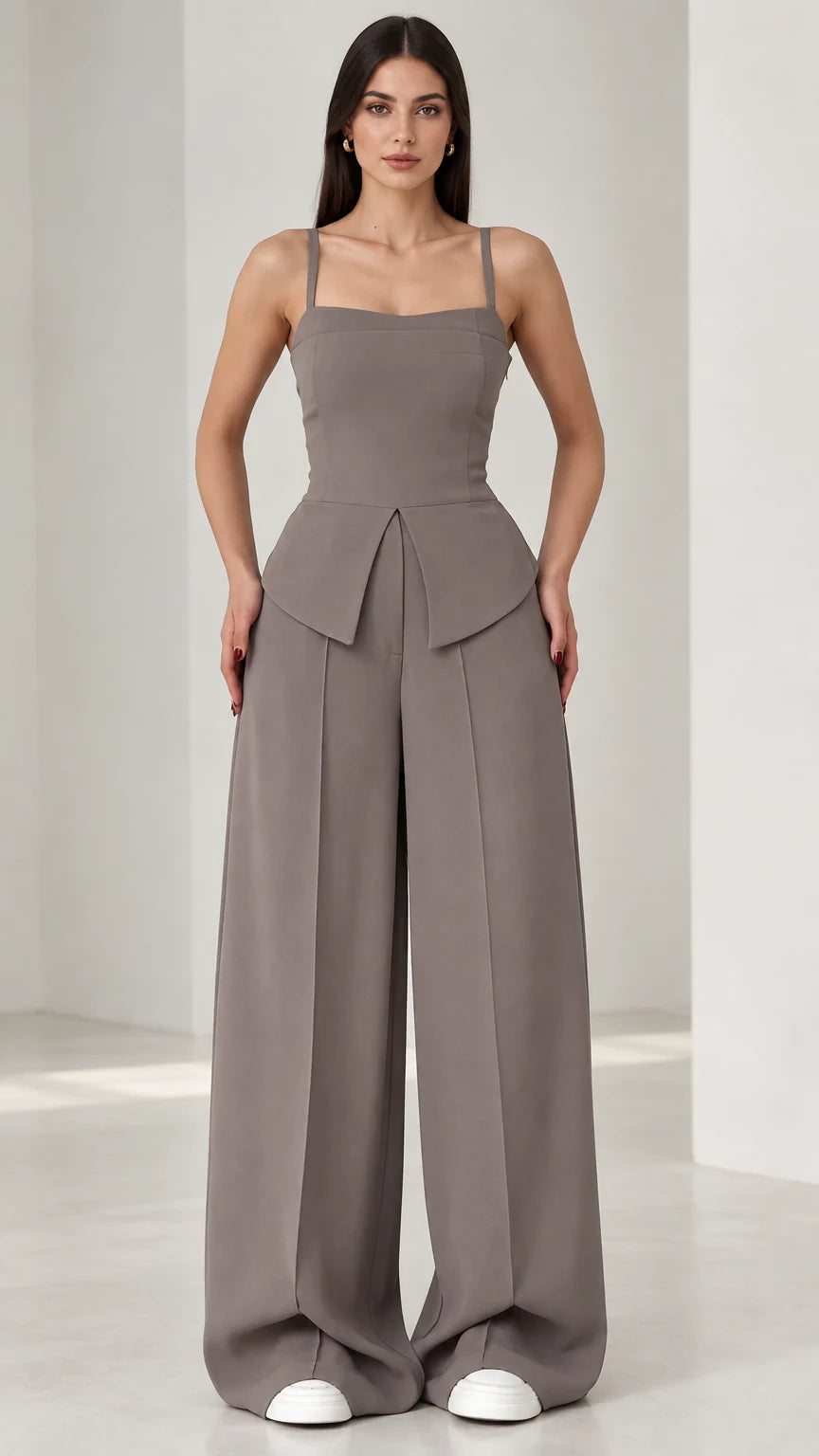 Full front view of model wearing grey square neck peplum wide leg jumpsuit