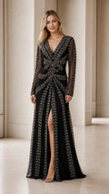 Model wearing black beaded long sleeve evening gown front view