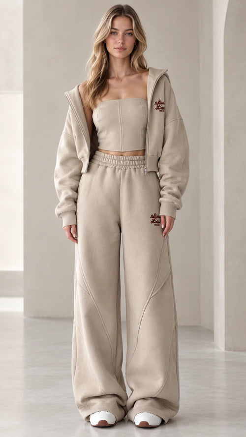 Front view of model wearing the oatmeal 3-piece cropped hoodie and wide-leg sweatpants set