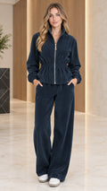 Front full-length view of woman wearing navy blue ribbed velour zip-up jacket and wide-leg lounge pants set