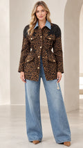 Full front view of model wearing brown leopard print utility jacket with denim collar and wide-leg jeans