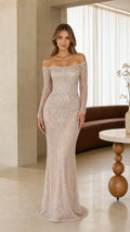 Full front view of model wearing champagne off-the-shoulder beaded long-sleeve evening gown