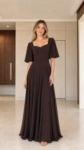 Front view of woman wearing chocolate brown sweetheart flutter sleeve maxi dress