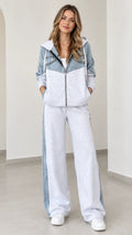 Front view of model wearing heather grey denim patchwork zip-up hoodie and wide-leg sweatpants set