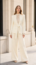 Full front view of model wearing a Cream belted blazer and wide-leg pant suit set