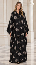 Front view of woman wearing black floral embroidered kaftan maxi dress with wide sleeves