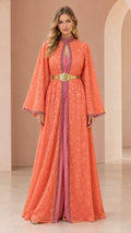 Front full view of woman wearing coral lace kaftan maxi dress with gold belt