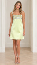Front view of model wearing Light Lime sequin embellished satin mini dress