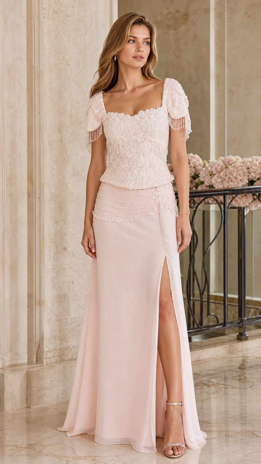 Front full-length view of woman wearing blush pink beaded evening gown with side slit