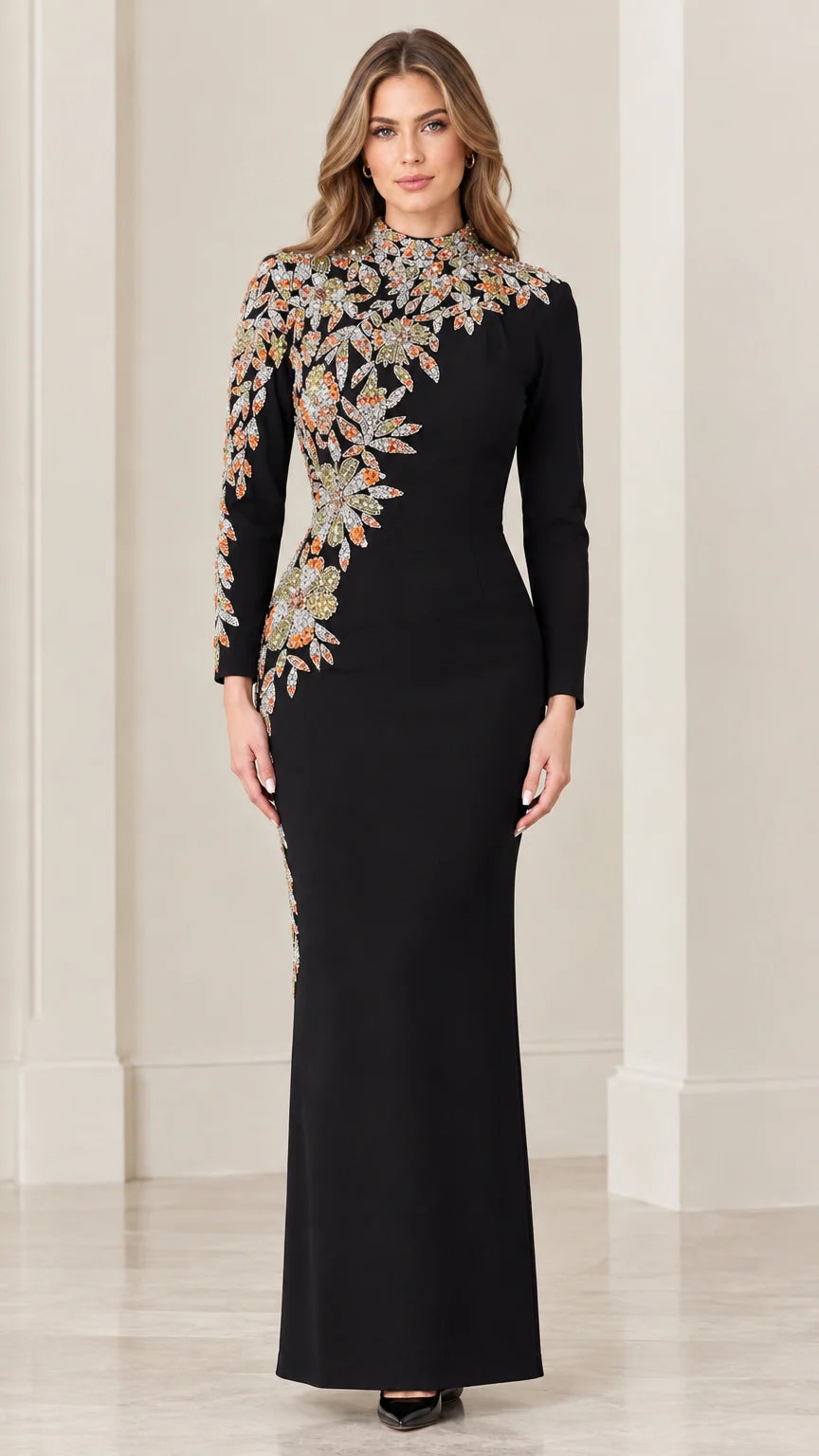 Front view of black long sleeve evening gown with asymmetrical floral embroidery
