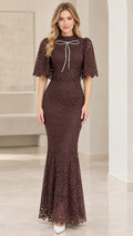 Front view of woman wearing chocolate brown lace capelet mermaid maxi dress with crystal bow