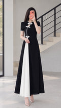 Full front view of black modern cheongsam maxi dress with white contrast panel