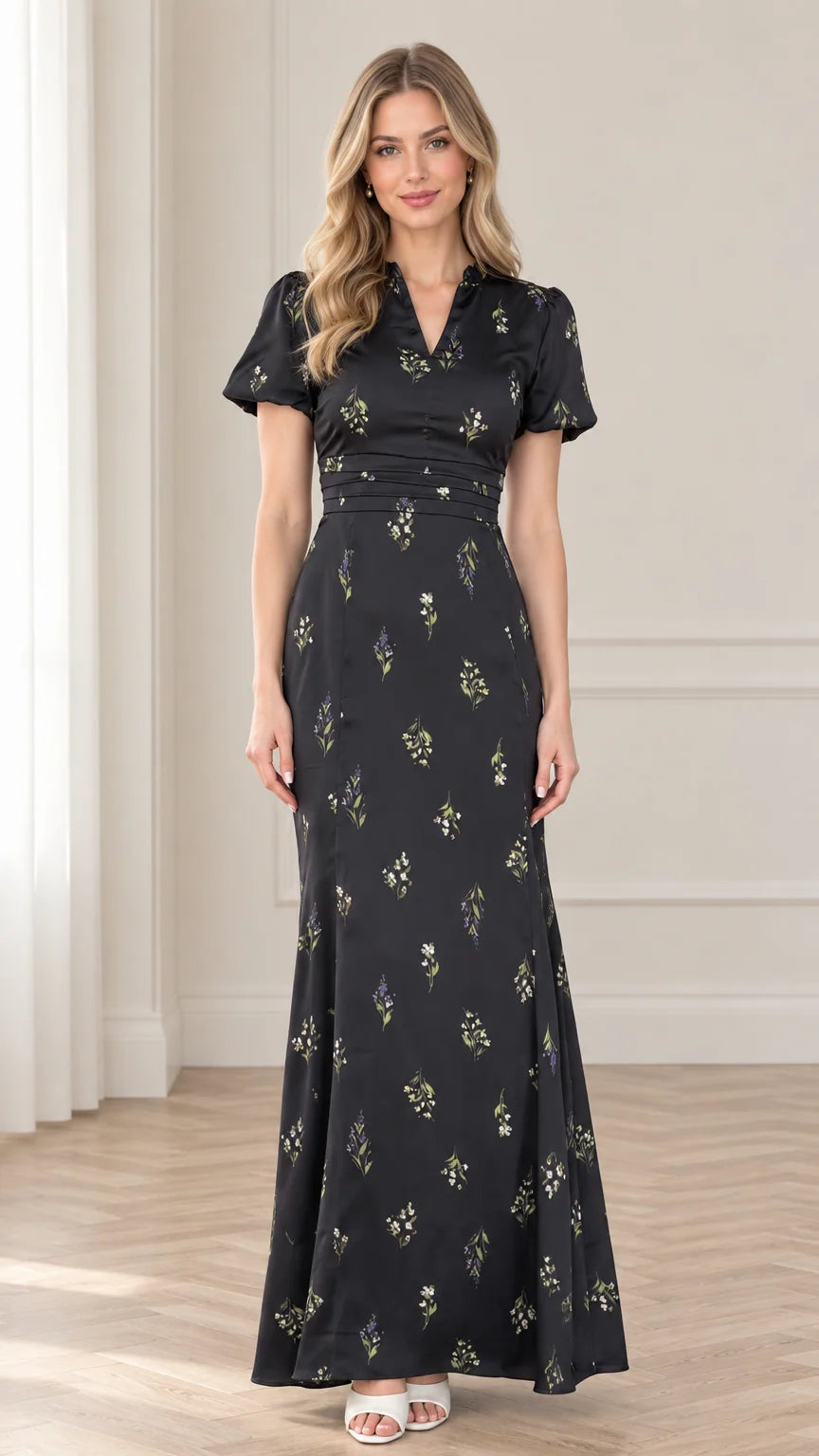 Front view of model wearing black floral print maxi dress with pleated waist and puff sleeves