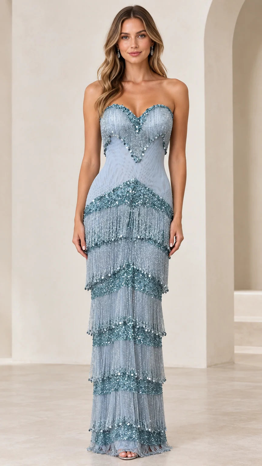 Front view of woman wearing dusty blue strapless beaded fringe maxi evening gown