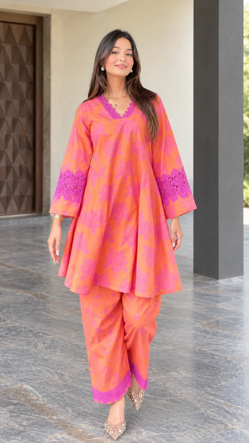 Front full view of woman wearing coral floral print flared tunic and pants set with lace trim