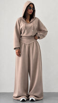 Front view of woman wearing taupe hooded sweatshirt and wide leg sweatpants lounge set